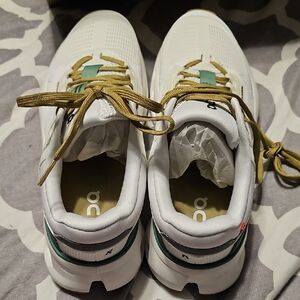 On Running White and Gold Shoes